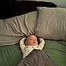 baby, sleeping, bed, blanket, pillow, infant, child, rest, cozy, peaceful, indoors, person, sleepwear, comfort, relaxation, yoga_pose, soft_lighting, cute, toddler, nap