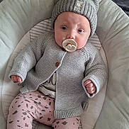 Delilah Denise is registered to the contest to win money with this photo: baby, baby_nest, blanket, cardigan, child, comfortable, cozy, cute, indoor, infant, knit_hat, pacifier, patterned_leggings, pillow, pink_leggings, portrait, resting, socks, soft_fabric, warm_clothing