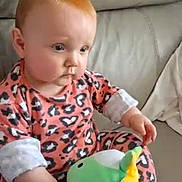 Delilah Denise joined the competition — help win amazing prizes! baby, child, infant, plush_toy, stuffed_animal, couch, sofa, pink_clothing, animal_print, indoor, face, person, video_call, screen, hand, sitting, expression, hair, adult, woman
