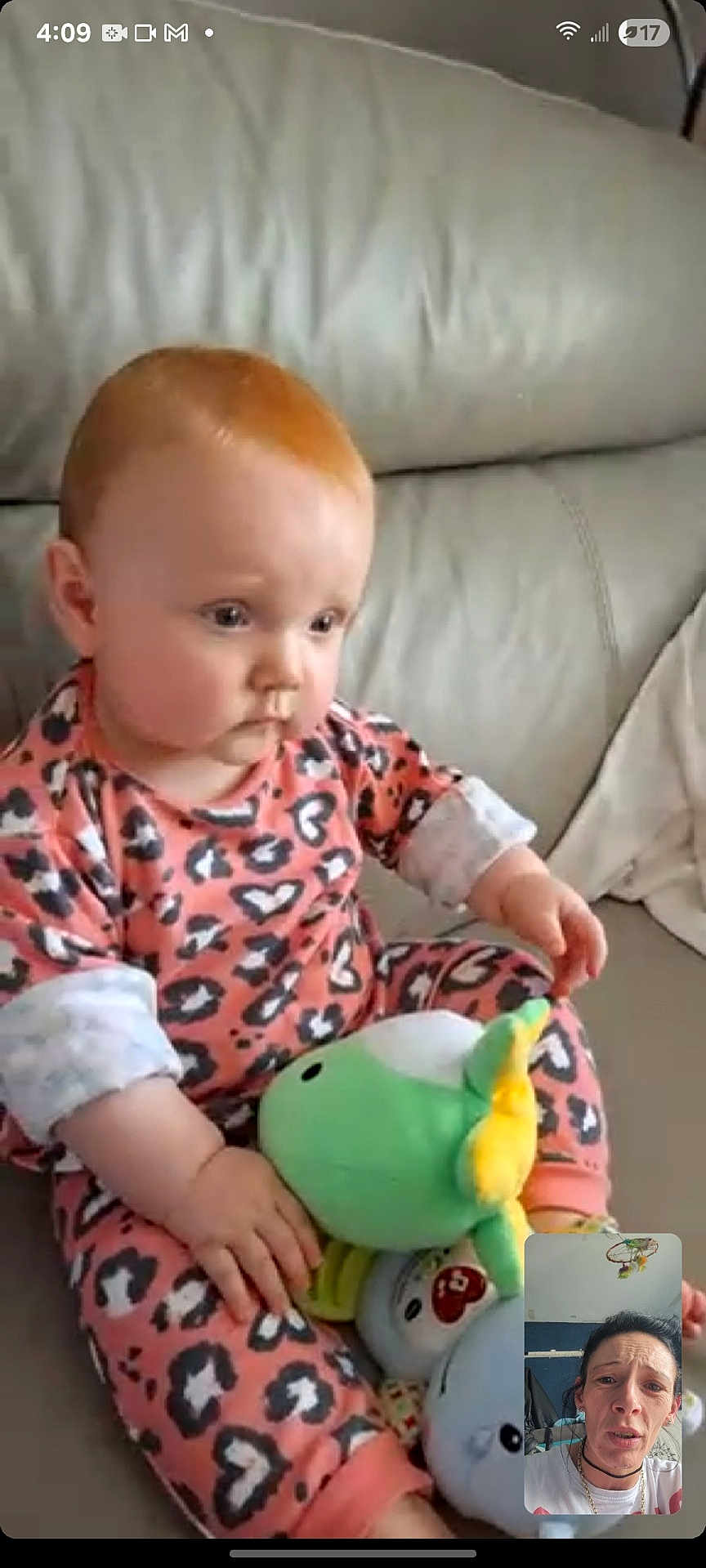 Delilah Denise joined the competition — help win amazing prizes! baby, child, infant, plush_toy, stuffed_animal, couch, sofa, pink_clothing, animal_print, indoor, face, person, video_call, screen, hand, sitting, expression, hair, adult, woman
