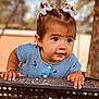 baby, bench, blue_dress, child, curious, cute, daylight, expression, face, hair_bows, hands, nature, outdoor, person, playground, portrait, skin, striped_clothing, toddler, young_child