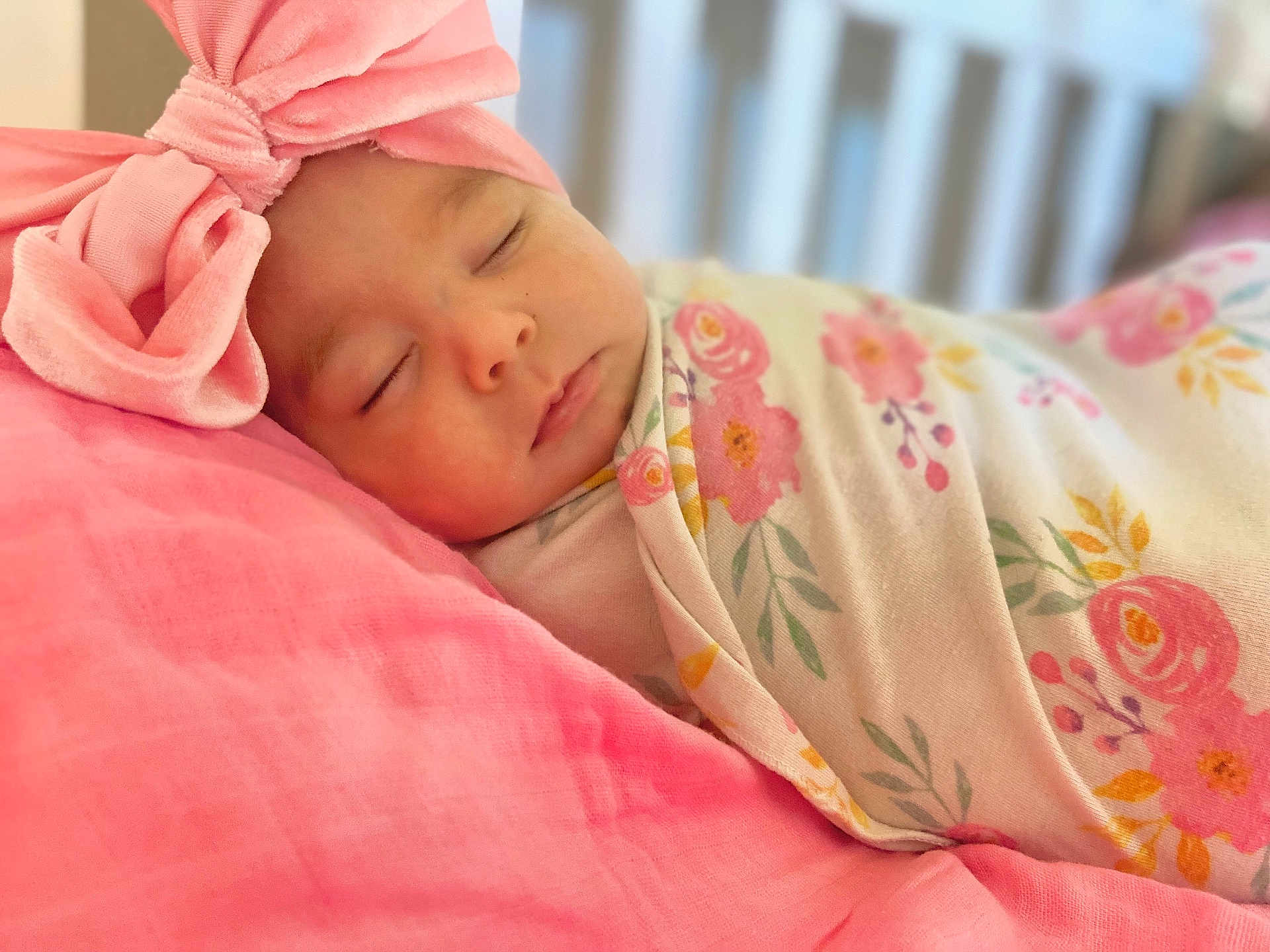 Kehlani joined the competition — help win amazing prizes! baby, sleeping, pink, headband, bow, blanket, floral, pillow, infant, peaceful, soft, cute, wrapped, resting, closeup, indoors, child, adorable, newborn, portrait
