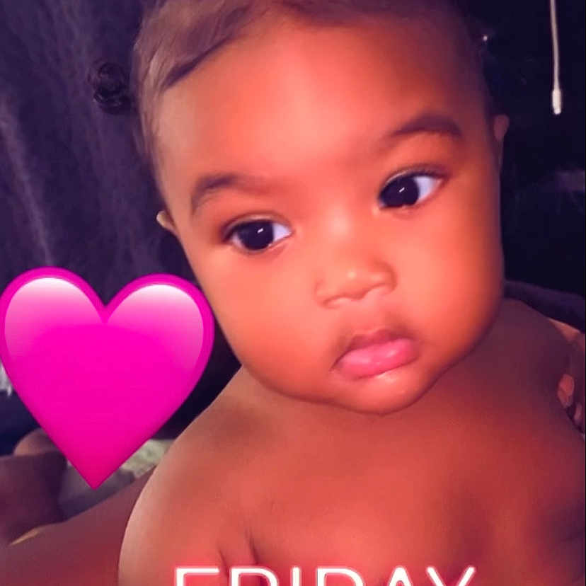 Londyn is registered to the contest to win money with this photo: baby, child, face, skin, curly_hair, expression, indoors, pink_heart, text_overlay, neon_text, friday, portrait, closeup, cute, infant, young_child, emotion, looking_away, warm_light, soft_skin