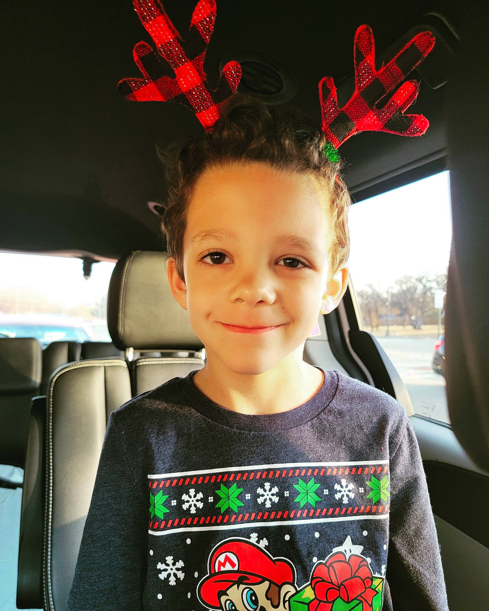 Oscar joined the competition — help win amazing prizes! automotive_design, automotive_lighting, black, car, car_seat, chin, cool, eye, flash_photography, forehead, happy, joy, motor_vehicle, person, red, skin, sleeve, smile, t_shirt, toddler