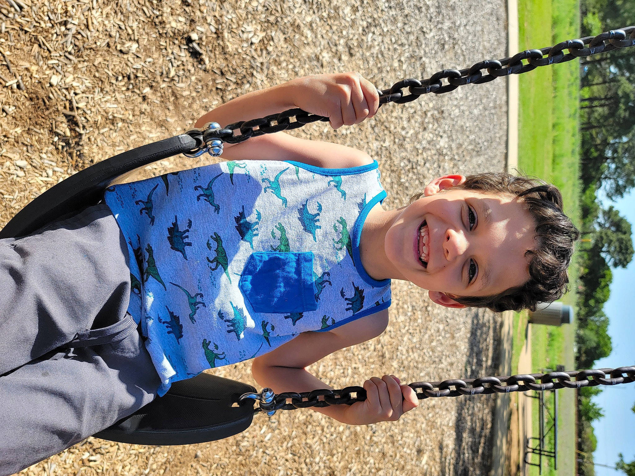 Oscar is registered to the contest to win money with this photo: child, elbow, electric_blue, eyewear, fun, grass, happy, human_leg, joy, landscape, leisure, pattern, people_in_nature, person, recreation, smile, summer, sunlight, toddler, tree