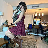 Bunny joined the competition — help win amazing prizes! woman, cat, indoor, dress, boots, living_room, smiling, furniture, table, lamp, rug, plant, kitchen, refrigerator, chair, portrait, happy, home, pet, cozy