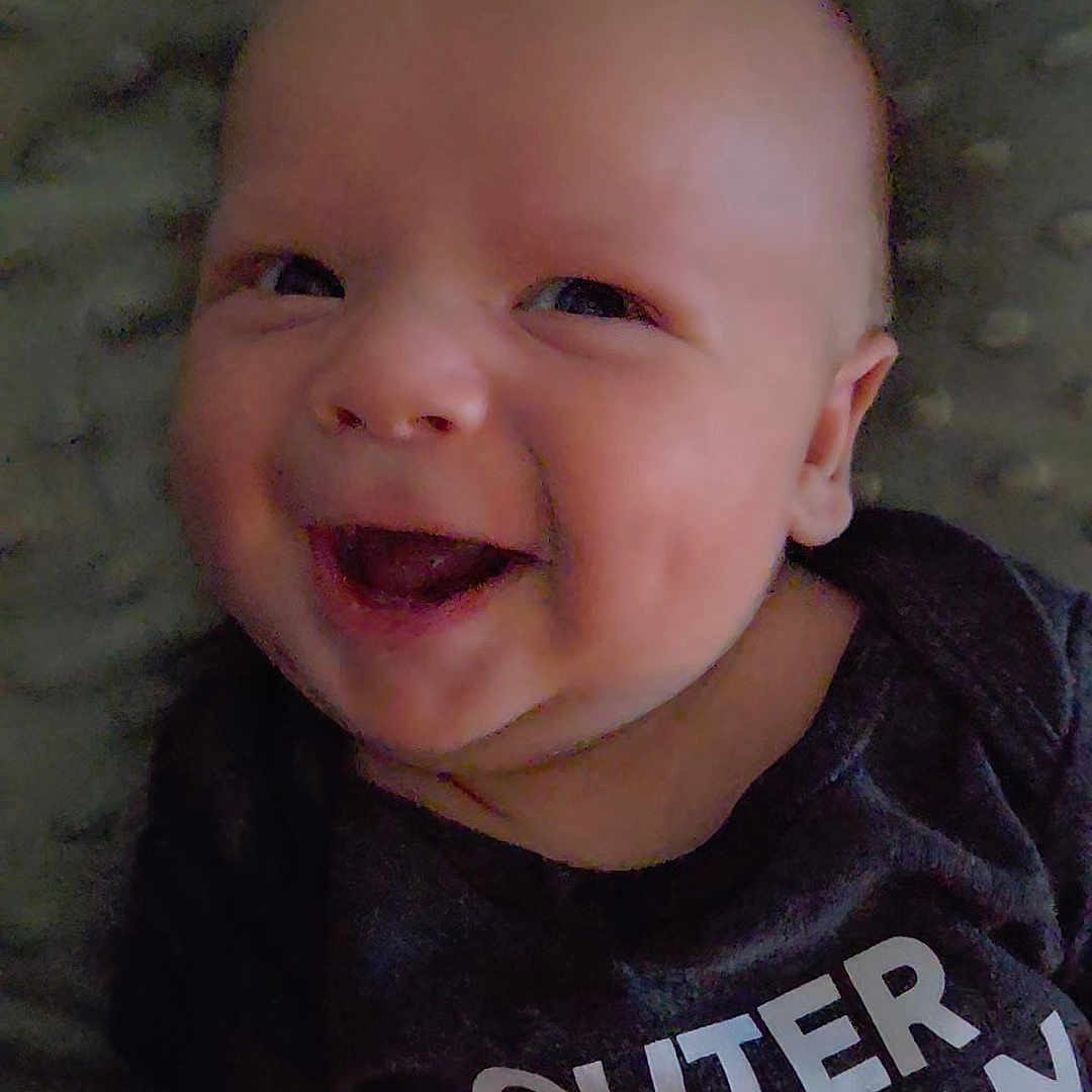 Blayne is registered to the contest to win money with this photo: baby, babylaughing, bodypart, clothing, face, happy, head, laughing, mouth, newborn, person, photography, portrait, smile, t_shirt, teeth