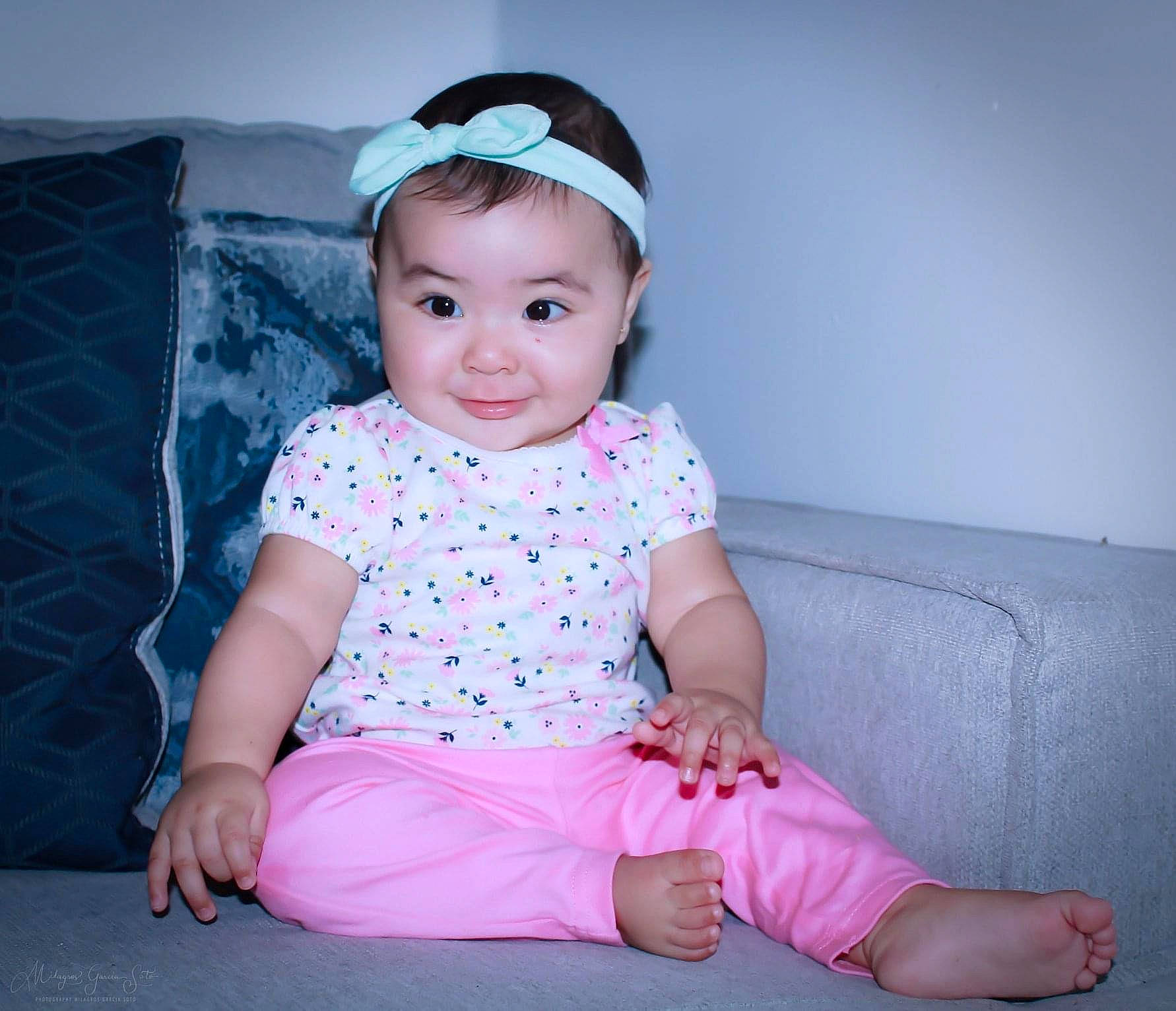 Alena is registered to the contest to win money with this photo: baby, baby_products, baby_toddler_clothing, cheek, child, child_model, costume, design, fashion_accessory, hair_accessory, head, headband, headgear, joy, pattern, person, pink, sitting, skin, sleeve