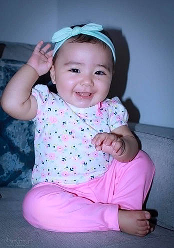 Alena is registered to the contest to win money with this photo: baby, baby_toddler_clothing, cheek, child, facial_expression, head, headgear, joy, pattern, person, pink, sitting, skin, sleeve, smile, toddler