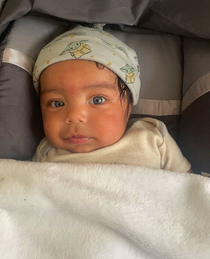 Kyro is registered to the contest to win money with this photo: baby, baby_products, baby_safety, baby_sleeping, bedding, blanket, cap, cheek, child, comfort, eye, eyebrow, headgear, headwear, linens, person, room, smile, toddler