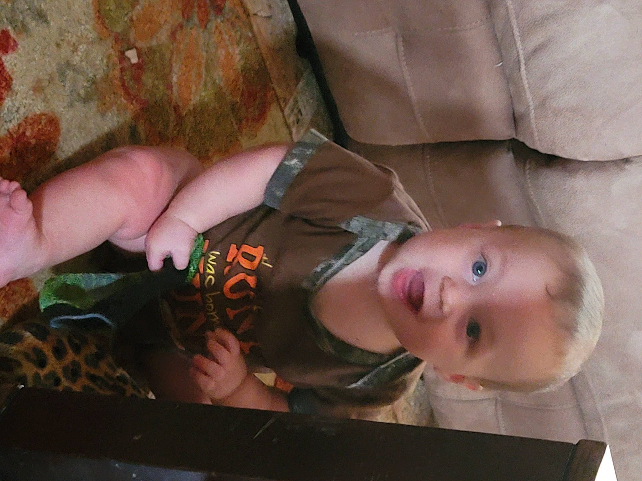 Braceson is registered to the contest to win money with this photo: baby, baby_products, baby_toddler_clothing, cheek, child, comfort, eye, face, hand, human_body, mouth, nail, pattern, person, sitting, skin, smile, thumb, toddler, wood