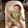 Anahi joined the competition — help win amazing prizes! baby, smiling, infant, onesie, baby_bouncer, floral_pattern, happy, child, face, skin, arm, leg, wooden_floor, indoor, furniture, person, cute, comfort, seat, relaxation