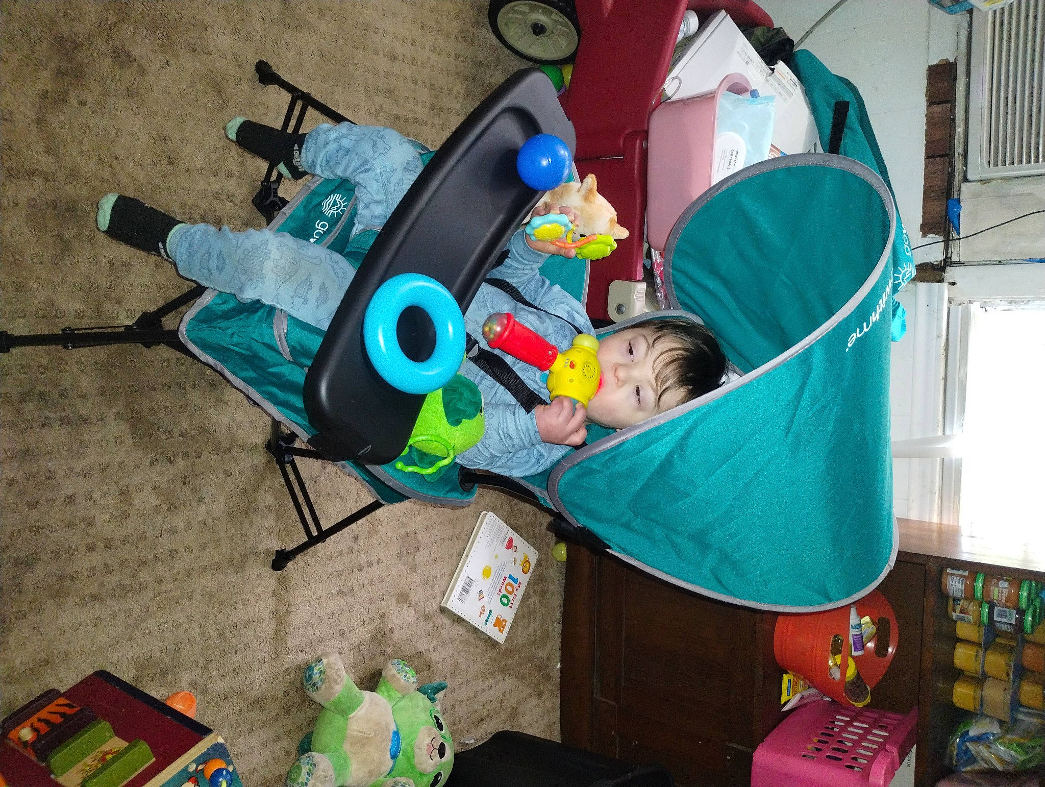 William joined the competition — help win amazing prizes! baby, baby_products, baby_safety, baby_toys, blue, child, event, fun, green, hat, leisure, medical_equipment, person, plastic, room, toddler, toy, wheel