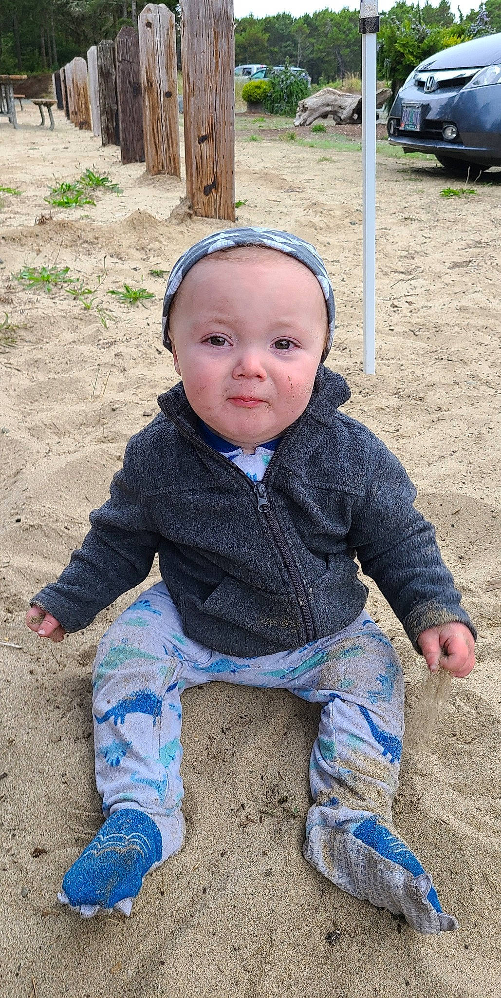 Benji is registered to the contest to win money with this photo: baby, baby_toddler_clothing, cap, cheek, child, chin, fun, grass, happy, head, leisure, pattern, person, recreation, sand, sitting, sleeve, soil, sunglasses, toddler