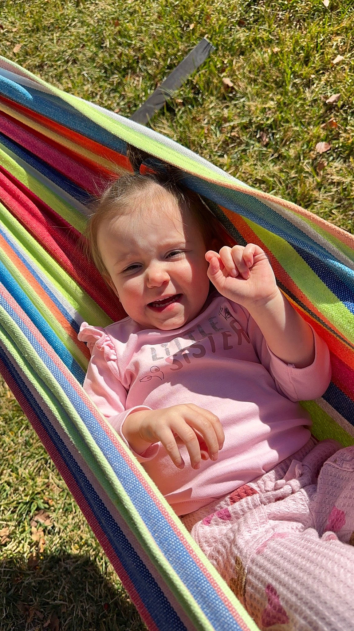 Aurora is registered to the contest to win money with this photo: baby, beauty, child, comfort, facial_expression, fun, grass, happy, leaf, leisure, nature, people, person, pink, product, recreation, sitting, skin, tints_and_shades, toddler