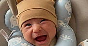 Sylas is registered to the contest to win money with this photo: baby, infant, child, smiling, laughing, portrait, seated, high_chair, baby_hat, bear_hat, neck_pillow, blanket, animal_print, bunny_pattern, cozy, indoors, close_up, happy, baby_gear, playful