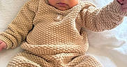 Sylas joined the competition — help win amazing prizes! baby, bear_hat, bed, beige, blanket, child, clothing, cozy, curtains, eyes, face, hat, indoor, infant, knitwear, lying_down, pants, portrait, sitting, sweater
