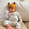 Sylas joined the competition — help win amazing prizes! baby, infant, child, portrait, smiling, sitting, bear_hat, knit_hat, onesie, white_clothing, bare_feet, couch, pillows, blanket, indoor, home, window, curtains, soft_lighting, cute