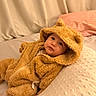 baby, bear_hood, bed, bedding, bedroom, blanket, child, cozy, face, fuzzy_clothing, hood, indoor, infant, lying_down, onesie, pillow, portrait, sitting, teddy_bear, wide_eyes