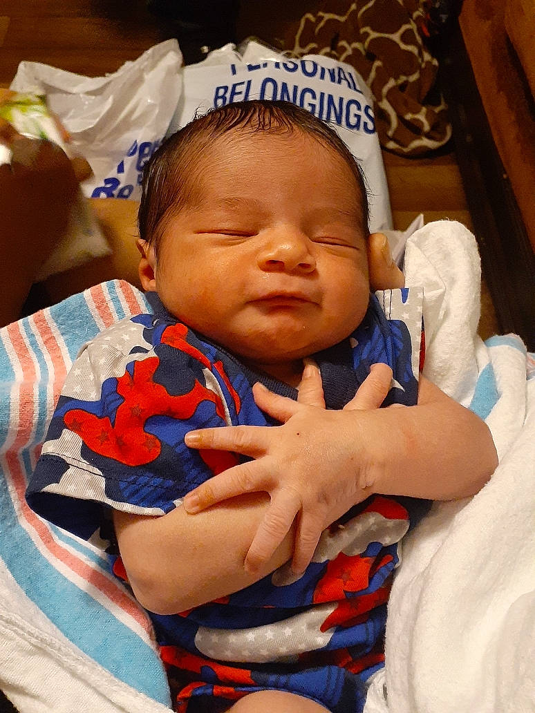 Moses joined the competition — help win amazing prizes! baby, baby_products, baby_sleeping, baby_toddler_clothing, cheek, child, comfort, event, finger, gesture, happy, linens, mouth, nose, orange, person, room, skin, textile, thumb