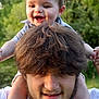 baby, child, man, smile, happy, outdoor, nature, greenery, shoulders, portrait, face, hair, beard, dimple, foot, hand, holding, casual_clothing, daylight, family