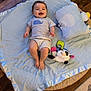 Walker is registered to the contest to win money with this photo: baby, smiling, child, blanket, plush_toy, panda, pillow, wooden_floor, blue_blanket, striped_shirt, whale_design, shorts, happy, indoor, soft_toy, floor, infant, cute, playtime, cozy