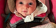 Oakylen is registered to the contest to win money with this photo: baby, infant, car_seat, blanket, hood, cute, child, face, eyes, clothing, pink, soft, cozy, seatbelt, indoors, portrait, expression, newborn, wearing, baby_toy