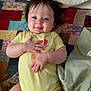 Oakylen is registered to the contest to win money with this photo: baby, blanket, child, cozy, cute, face, hands, happy, head, indoor, infant, legs, lying_down, patchwork_quilt, person, playful, skin, smile, soft_lighting, yellow_onesie
