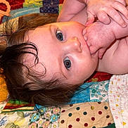 Oakylen joined the competition — help win amazing prizes! baby, infant, child, face, hand, skin, hair, blue_eyes, blanket, quilt, pattern, colorful, lying_down, portrait, cute, young, baby_hands, indoors, closeup, sleepwear