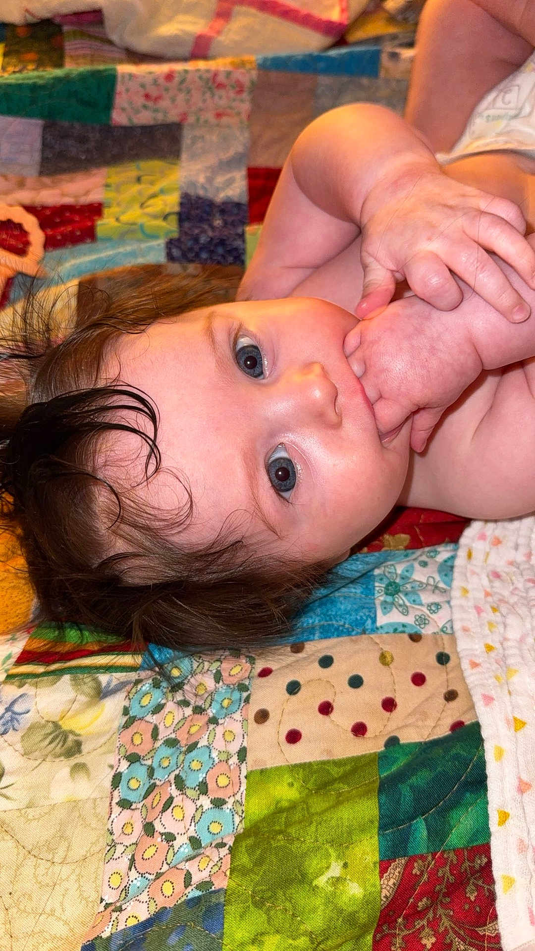Oakylen joined the competition — help win amazing prizes! baby, infant, child, face, hand, skin, hair, blue_eyes, blanket, quilt, pattern, colorful, lying_down, portrait, cute, young, baby_hands, indoors, closeup, sleepwear