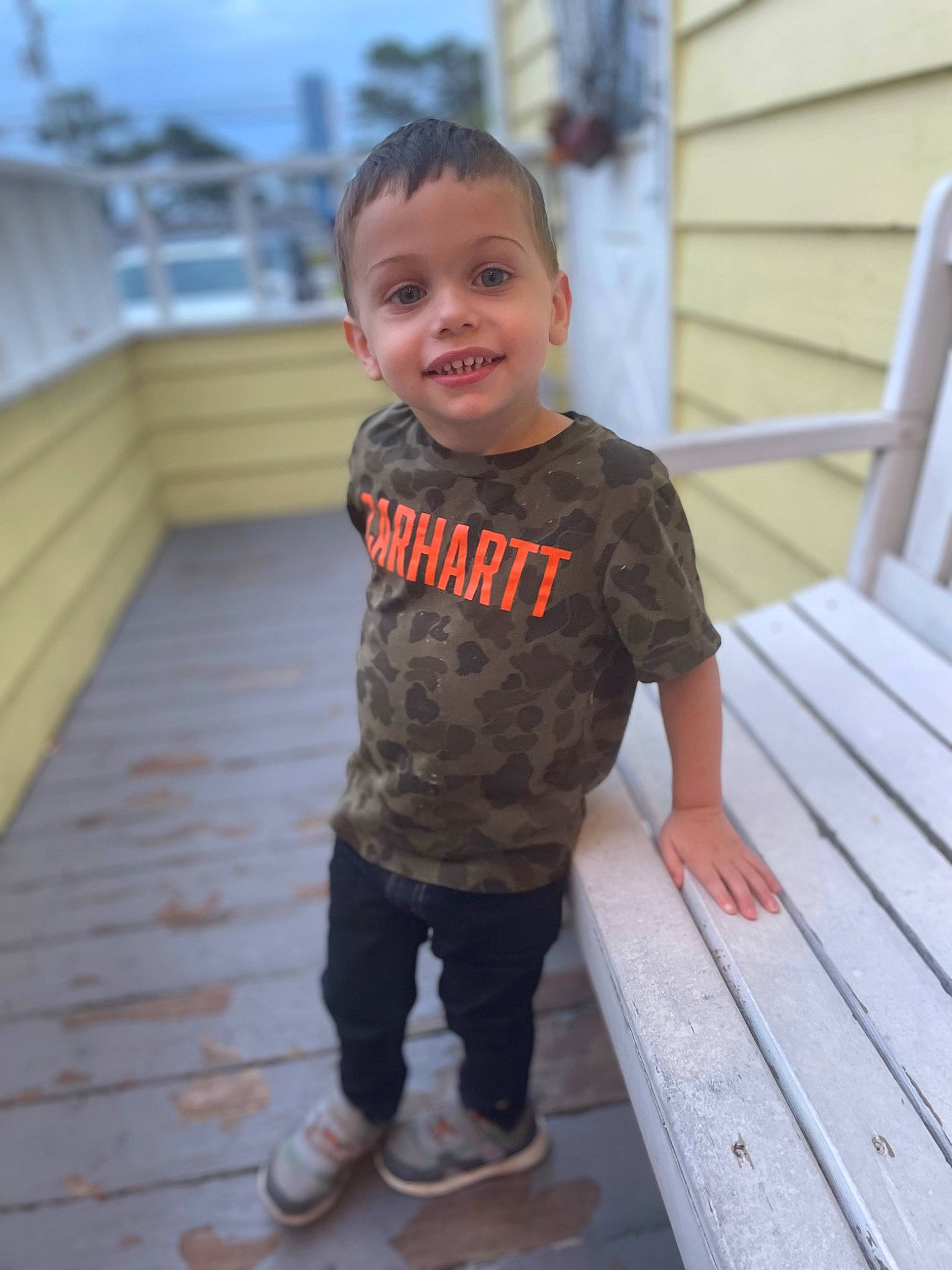 Landon is registered to the contest to win money with this photo: baby, baby_toddler_clothing, child, clothing, face, flooring, happy, hardwood, human, joy, leisure, nose, outerwear, person, sky, sleeve, smile, standing, t_shirt, toddler