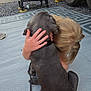 Cash is registered to the contest to win money with this photo: dog, child, hugging, outdoor, mat, camper, grill, gray_dog, blond_hair, summer, leash, human_hand, barefoot, relaxing, grass, gravel, wheel, shoe, nature, bond