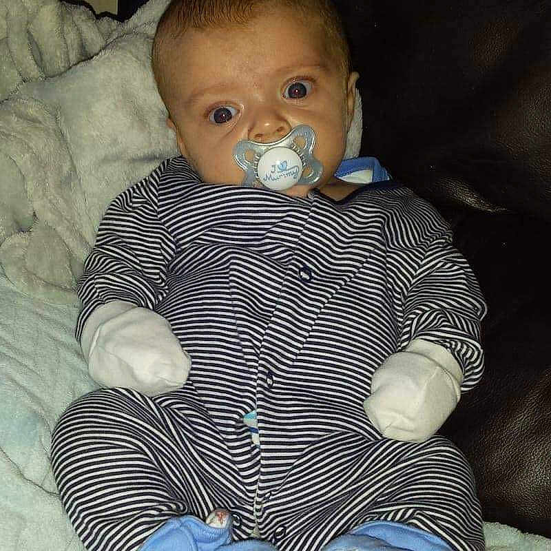 Lucas joined the competition — help win amazing prizes! baby, bed, blanket, clothing, couch, cushion, face, furniture, head, homedecor, hosiery, jeans, newborn, pants, person, photography, portrait, sitting, sock, toy