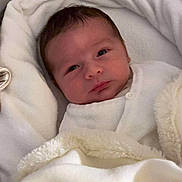 Giani participe au concours pour gagner de l'argent avec cette photo : baby, blanket, bassinet, white, soft, infant, face, newborn, sleeping_area, clothing, cute, portrait, child, resting, indoors, warm, comfort, skin, head, eyes