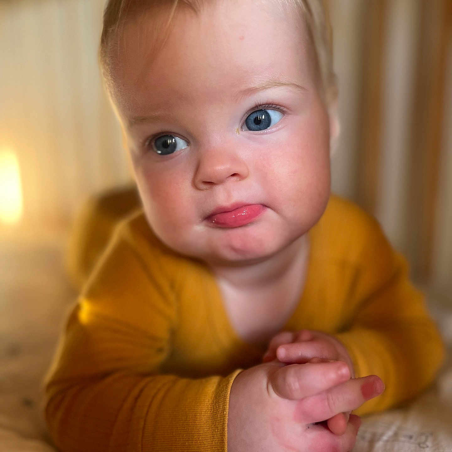 Lila is registered to the contest to win money with this photo: baby, blonde, bodypart, clothing, face, finger, hair, hand, happy, head, knitwear, newborn, person, photography, portrait, sitting, skin, smile, tattoo, wrist