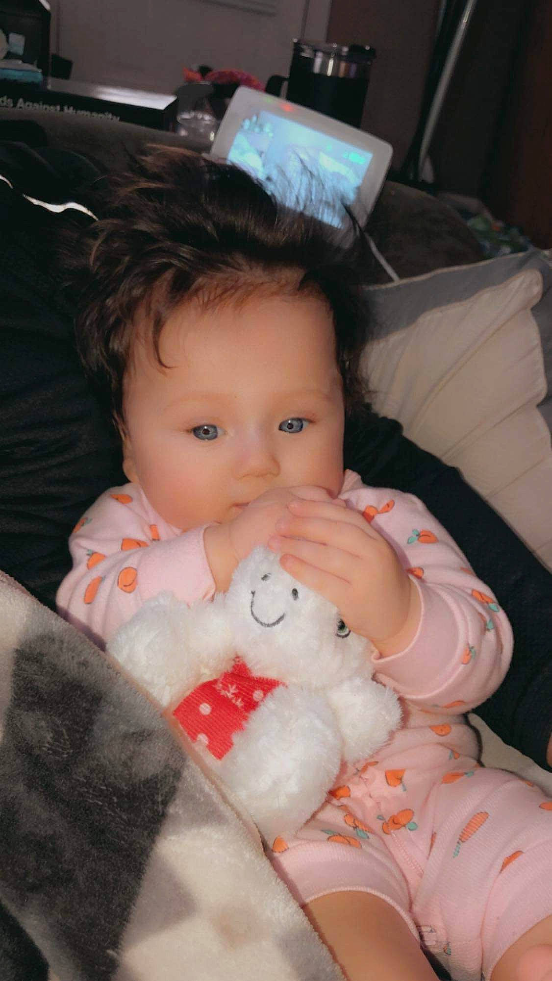 Katarina is registered to the contest to win money with this photo: baby, baby_toddler_clothing, carmine, cheek, child, chin, comfort, eye, face, finger, head, iris, lap, lip, mouth, nose, person, sitting, skin, textile