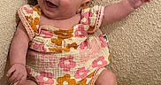 Eleanor joined the competition — help win amazing prizes! baby, child, infant, smiling, happy, sitting, portrait, face, couch, sofa, cushion, floral_outfit, romper, pink, beige, indoor, home, barefoot, waving, photography