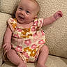 baby, child, infant, smiling, happy, sitting, portrait, face, couch, sofa, cushion, floral_outfit, romper, pink, beige, indoor, home, barefoot, waving, photography