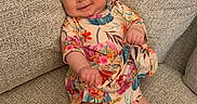 Eleanor joined the competition — help win amazing prizes! baby, bow, child, colorful_clothing, couch, eyes, face, floral_outfit, furniture, hands, headband, home, indoor, infant, legs, photography, portrait, relaxed, sitting, smiling