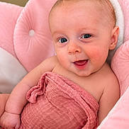 Eleanor joined the competition — help win amazing prizes! baby, infant, smile, pink_blanket, pink_chair, child, cute, portrait, happy, skin, face, eyes, newborn, soft_texture, cozy, indoor, expression, wrapped, seated, warm