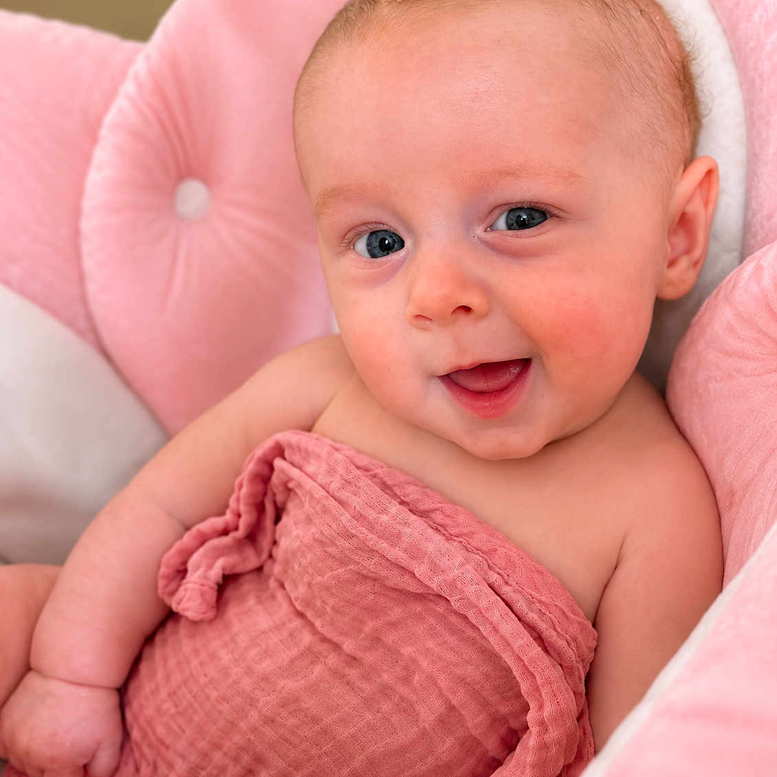 Eleanor joined the competition — help win amazing prizes! baby, infant, smile, pink_blanket, pink_chair, child, cute, portrait, happy, skin, face, eyes, newborn, soft_texture, cozy, indoor, expression, wrapped, seated, warm