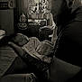 baby, man, tattoo, sleeping, indoor, window, lamp, pumpkin, jack_o_lantern, halloween, sign, furniture, curtain, shirt, shorts, beard, ear_gauge, person, holding, cozy