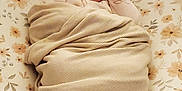 Lillian is registered to the contest to win money with this photo: newborn, baby, swaddled, blanket, sleeping, floral, cushion, infant, cozy, resting, bedroom, soft, cute, peaceful, portrait, wrapped, head, face, person, indoors