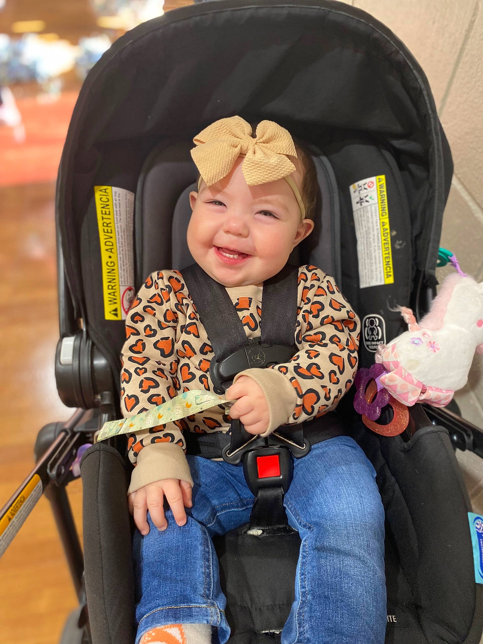 Alivia is registered to the contest to win money with this photo: auto_part, baby, baby_carriage, baby_products, baby_toddler_clothing, car_seat, child, comfort, electric_blue, eye, fun, happy, headwear, joy, lap, person, sitting, smile, tire, toddler