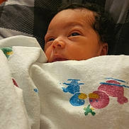 Josslyn is registered to the contest to win money with this photo: newborn, baby, blanket, cartoon, colorful, cushion, checkered, face, infant, indoors, person, resting, sleepy, soft, toddler, warm, wrapped, young, cute, cozy