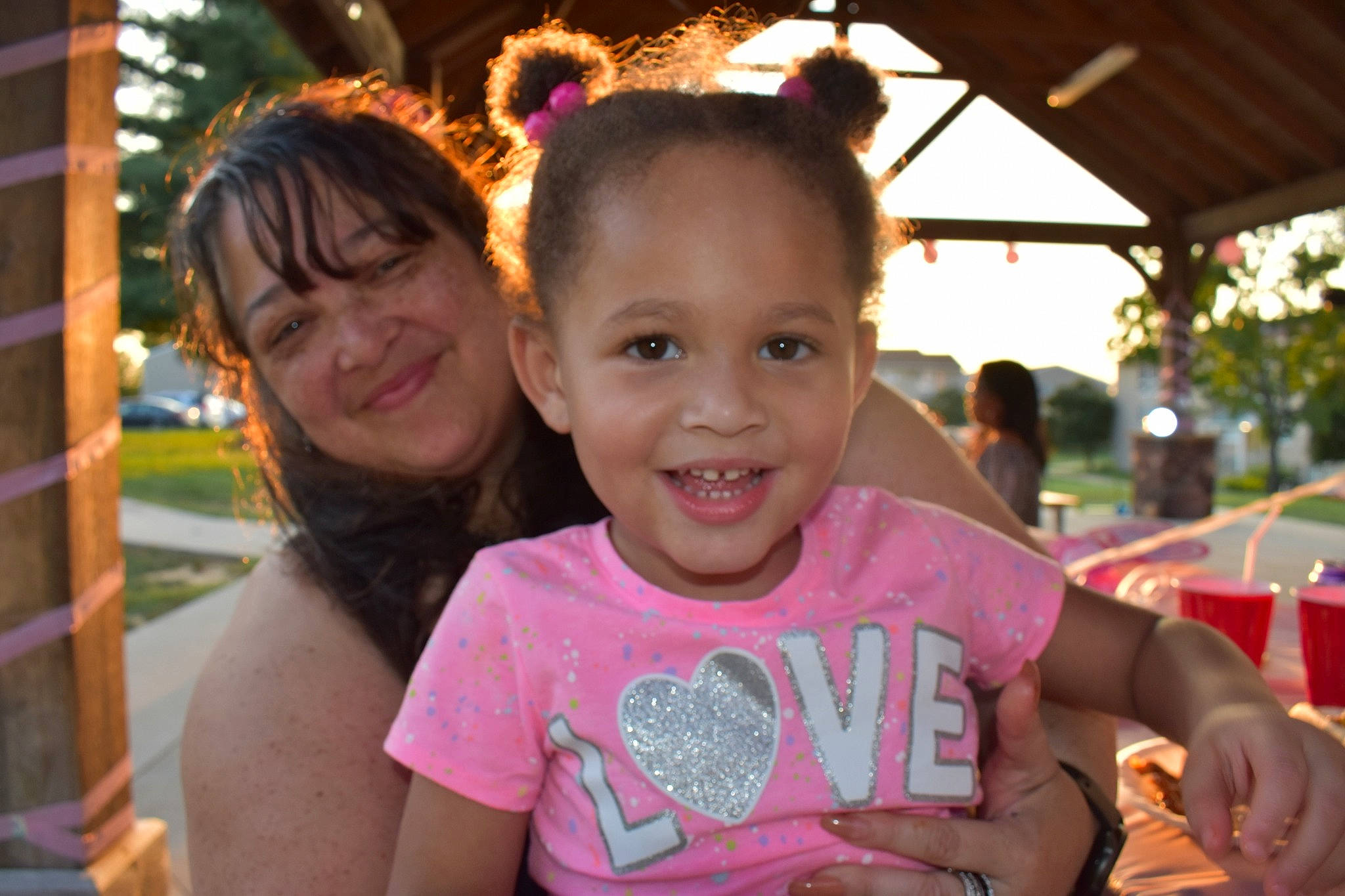 Isabella is registered to the contest to win money with this photo: child, community, event, face, facial_expression, friendship, fun, happy, joy, leaf, leisure, magenta, person, pink, plant, recreation, smile, social_group, summer, t_shirt