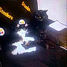 Lilly Mae is registered to the contest to win money with this photo: cat, black_cat, black_and_white_cat, chair, pittsburgh_steelers_logo, logo, indoor, pets, feline, fur, resting, seated, animal, domestic_animal, yellow_eyes, whiskers, paper, wall, shadow, dark