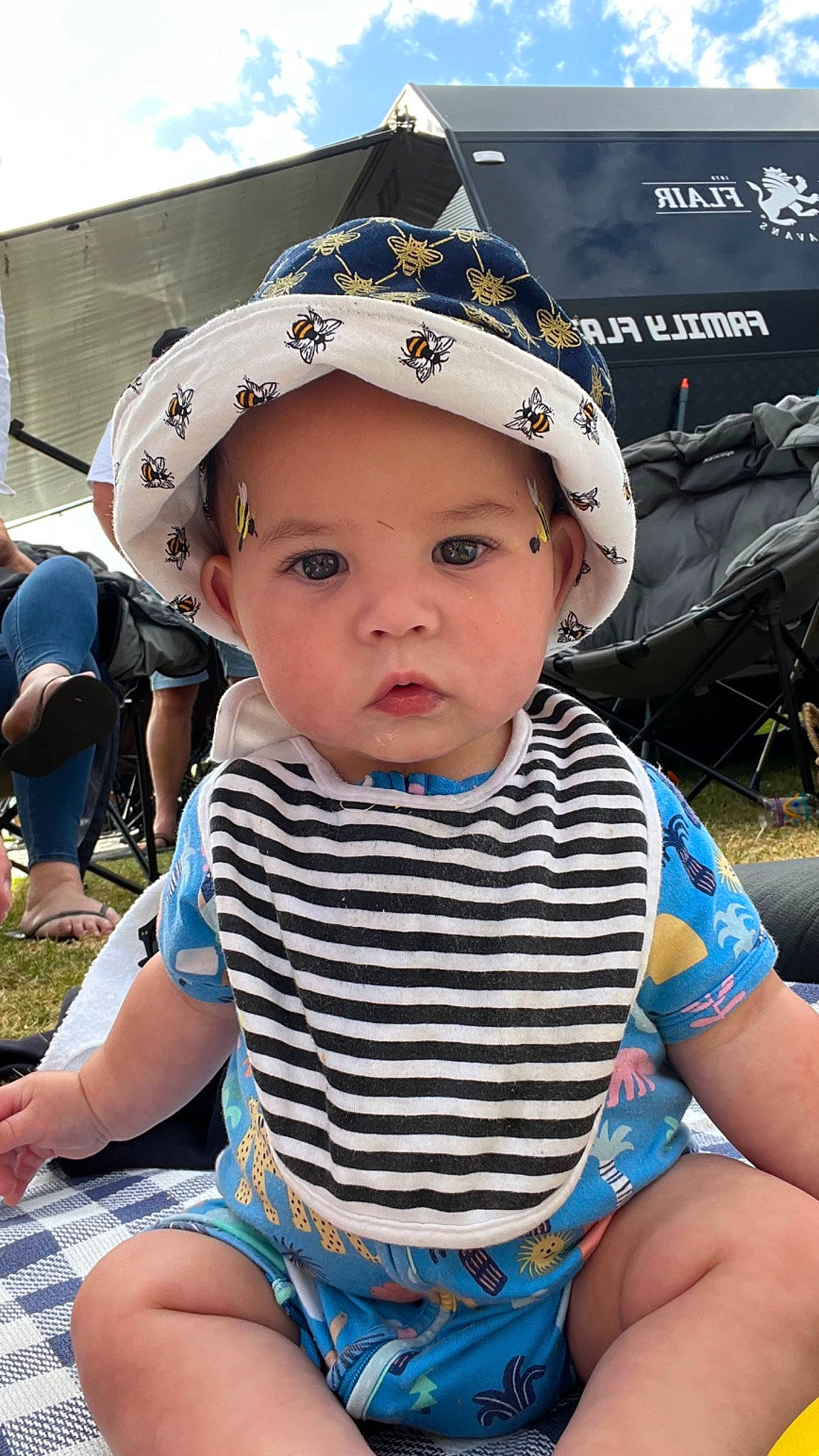 Jett is registered to the contest to win money with this photo: baby, baby_toddler_clothing, baseball_cap, cap, child, electric_blue, fashion_accessory, fun, grass, happy, hat, headwear, leisure, person, recreation, shorts, sitting, skin, summer, sun_hat