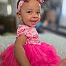 baby, child, toddler, smiling, portrait, pink, dress, tutu, headband, bow, indoor, sitting, happy, face, eyes, earrings, fashion, infant, blurred_background, photography
