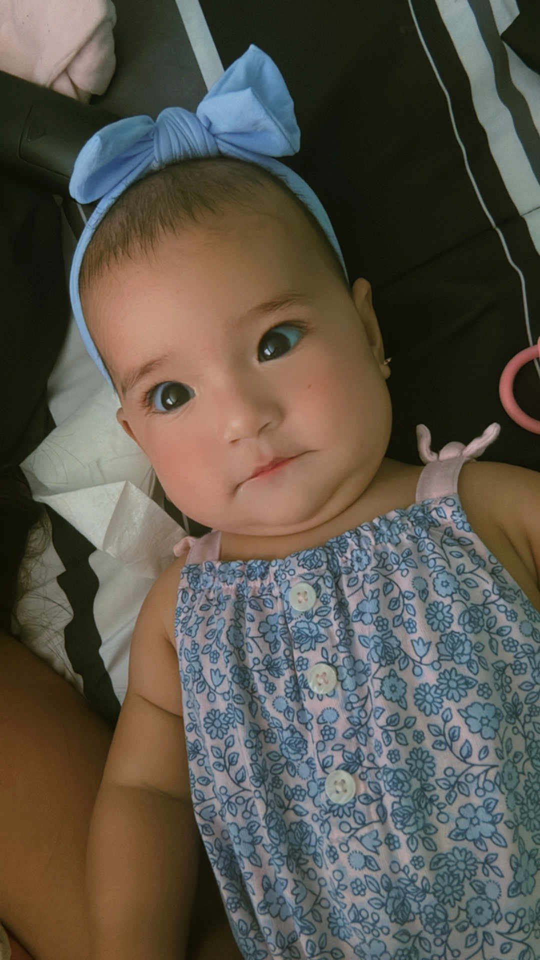 Ariadna joined the competition — help win amazing prizes! baby, child, headband, blue, dress, floral_pattern, face, eyes, earrings, skin, arm, lying_down, blanket, striped, cute, innocent, portrait, indoors, closeup, person